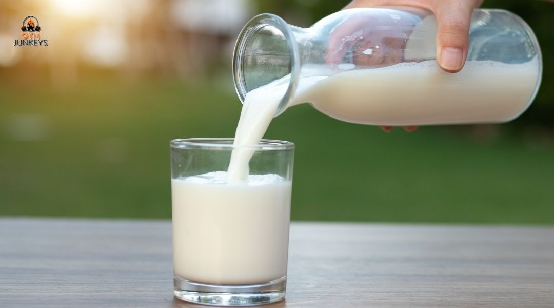 someone pouring milk into a glass