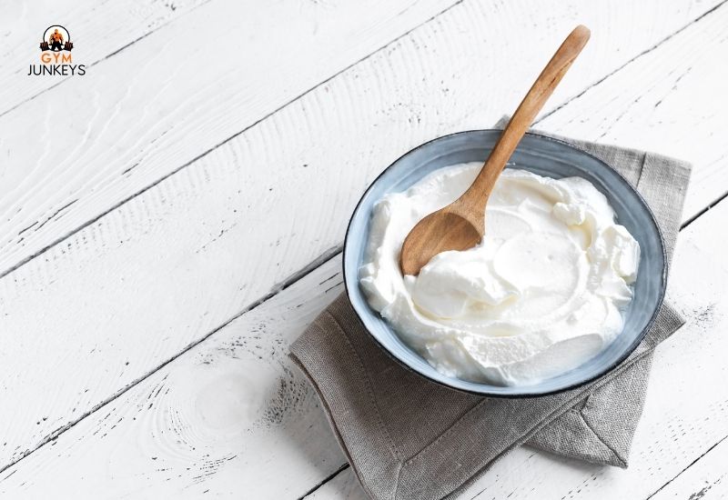 Greek Yogurt in a bowl with a wooden spoon
